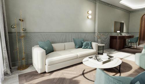 a living room with a white couch and a table at Grand Hotel Bristol in Stresa