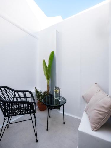 a living room with a table and a chair at Sunset Windmills House in Mýkonos City