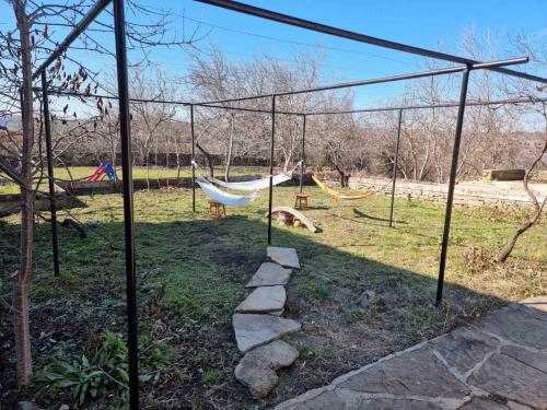 a playground with two hammocks in a park at Vedra Guest House in Ganchovets