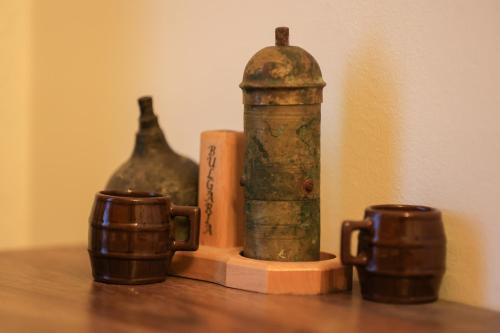 a table with two cups and two bottles on it at N'konak Guesthouse in Pukë