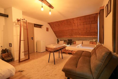 a living room with two beds and a couch at N'konak Guesthouse in Pukë