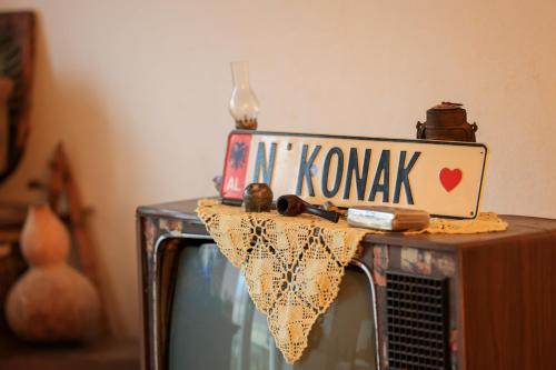 a street sign on top of a tv at N'konak Guesthouse in Pukë