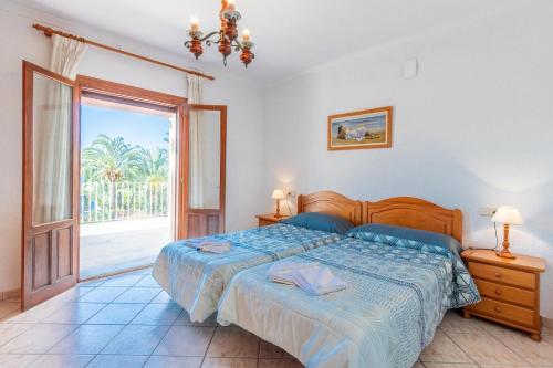 a bedroom with a bed and a sliding glass door at Merced in Calpe
