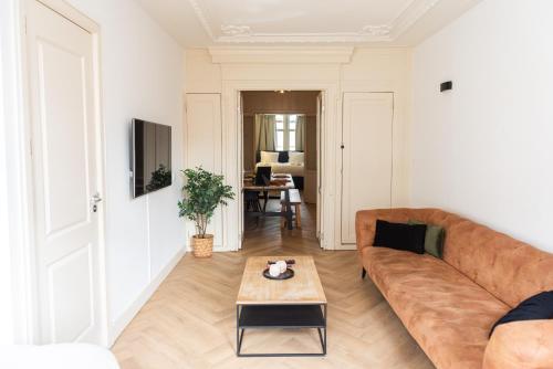 a living room with a couch and a table at Historic Canal House Apartment in Amsterdam