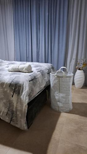 a bedroom with a bed with a basket next to it at Bella vista2023 only for Family in Cabo Negro
