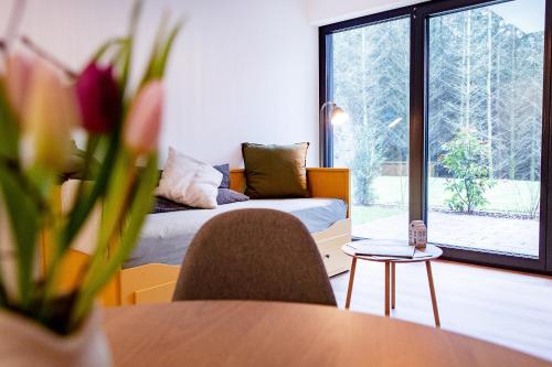 a living room with a couch and a table at NATURNEST Eifel in Daun