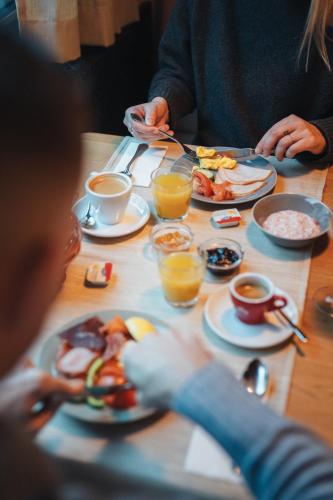 a group of people sitting at a table eating breakfast at Zermatt Budget Rooms in Zermatt