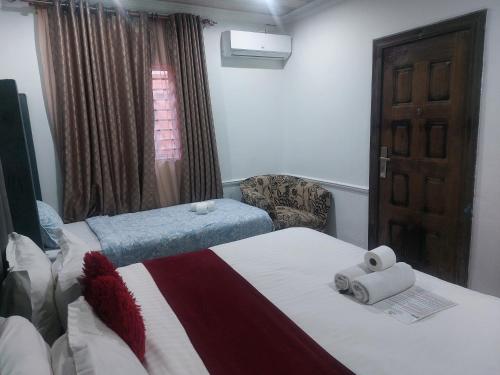 a hotel room with two beds and a window at Gold Crown International Hotel With Complementary Breakfast and WiFi in Johannesburg