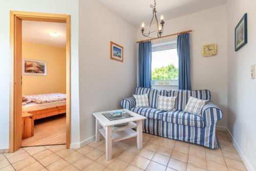 a living room with a couch and a table at Ferienhof Bruhn "Nr 3" in Midlum