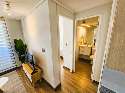 a room with a bathroom with a toilet and a sink at 2D con estacionamiento Fantastico Depto - D'Home in Concepción