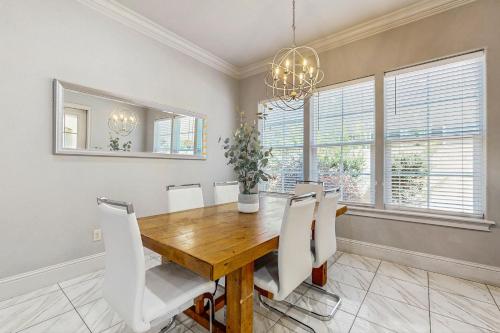 a dining room with a wooden table and white chairs at Miramar Beach Villas #946B in Destin