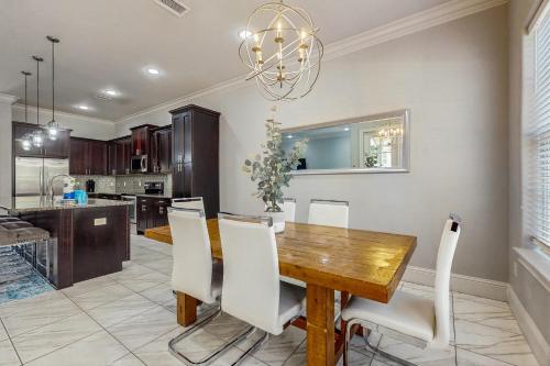 a dining room with a wooden table and white chairs at Miramar Beach Villas #946B in Destin