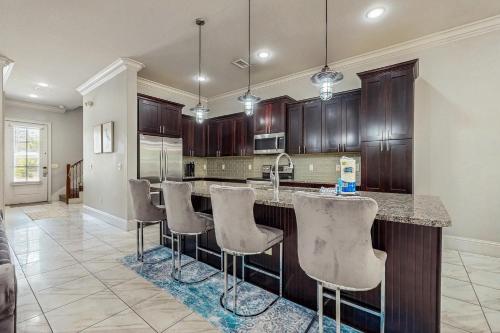 a kitchen with a island with bar stools at Miramar Beach Villas #946B in Destin