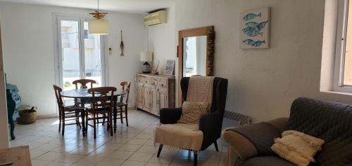 un salon avec une table et des chaises dans l'établissement Frejus Plage a 50m des plages, 1er etage de villa, à Fréjus