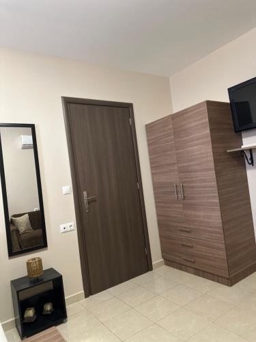 a room with a wooden door and a mirror at Mika's Paradise in Archangelos