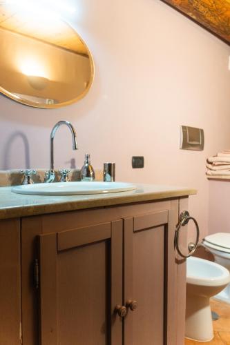 a bathroom with a sink and a mirror at Panoramic villa with pool in Bolsena