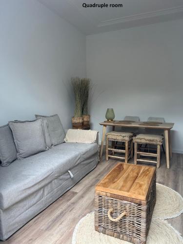 a living room with a couch and a table at El Sol Zandvoort in Zandvoort