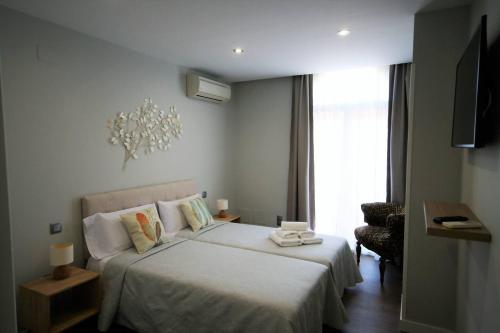 En eller flere senge i et værelse på Ático en la Gran Vía con Terraza al Palacio Real