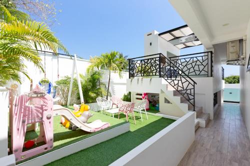ラワイビーチにあるZen Family - All-Inclusive-Pool - Playground - Panoramic Rooftop-4BR-3BA - Beach Minutes Awayのブランコと遊び場付きのバルコニー
