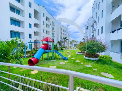 a playground in front of a apartment building at Caribe campestre coveñas in Coveñas