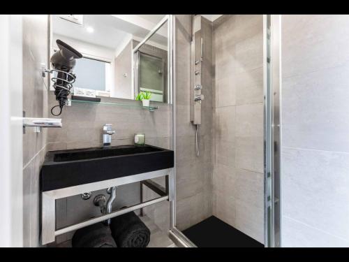 a bathroom with a sink and a shower at Duomo In 8 Stop in Milan