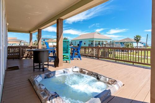 a hot tub on the deck of a house at Nauti By Nature home in Crystal Beach