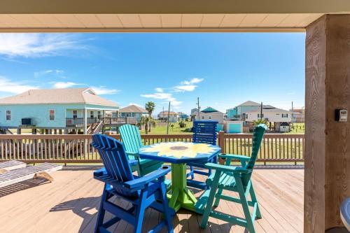 a patio with a table and chairs on a deck at Nauti By Nature home in Crystal Beach