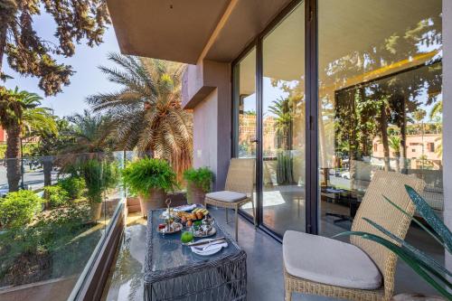 a balcony with a table with food on it at Luxury 1 BDR Hivernage in Marrakesh