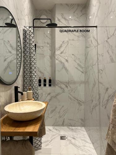a bathroom with a sink and a mirror at El Sol Zandvoort in Zandvoort
