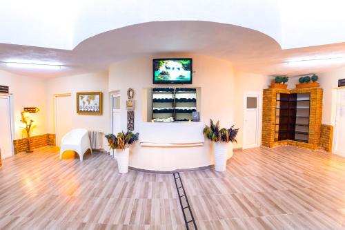 a waiting room with flowers in white vases at Continent Hotel Kapadokus Thermal in Guzelyurt