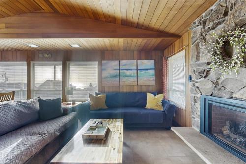 a living room with a blue couch and a fireplace at The Lucky Starfish in Lincoln City