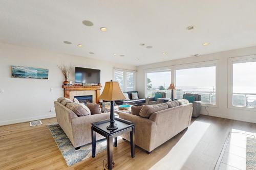 a living room with two couches and a fireplace at SeaLah in Lincoln City