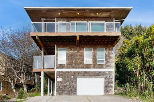 a brick building with a balcony on top of it at SeaLah in Lincoln City