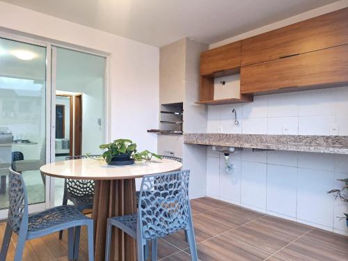 a kitchen with a table and chairs in a room at Casa de praia Imbassaí in Mata de Sao Joao