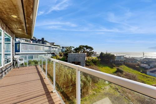 a balcony of a house with a view of the ocean at SeaLah in Lincoln City