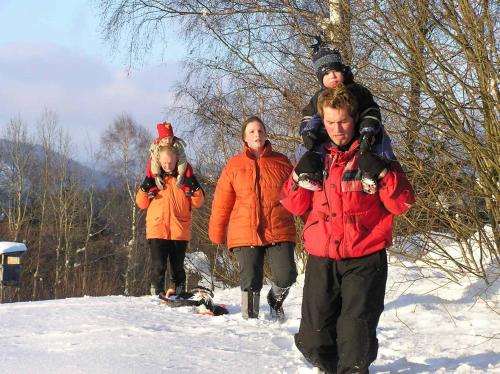 a group of people walking in the snow at Ferienwohnung Hinterdorfer in Unterweissenbach
