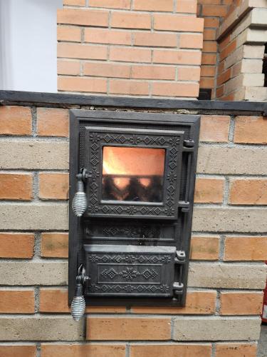 a black stove on the side of a brick wall at MONADIN Villa Relax & Spa in Săcele