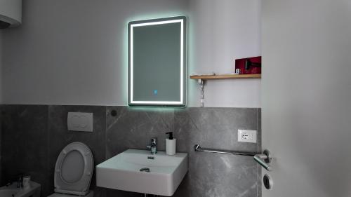 a bathroom with a white sink and a mirror at Bluemoon Retreat in Tirana