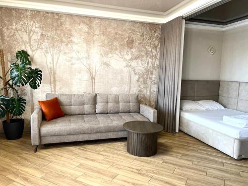 a living room with a couch and a bed at Old City apart in Lviv