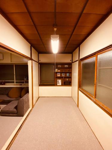 an empty room with a ceiling with a light on at 貸切古民家 ゆったどの宿 in Morioka