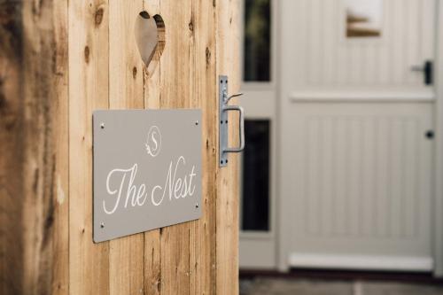 a door with a sign that reads the left at The Nest by Sedgewell Barn in Northallerton