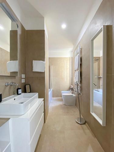 a bathroom with a sink and a toilet at Corti Segrete - Milano Centro in Milan