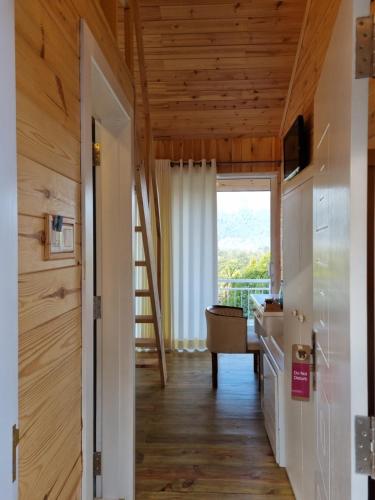 a room with a staircase leading to a kitchen with wood ceilings at Sisila rest in Gampola