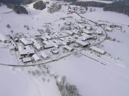 an aerial view of a village covered in snow at Ferienwohnung Hinterdorfer in Unterweissenbach