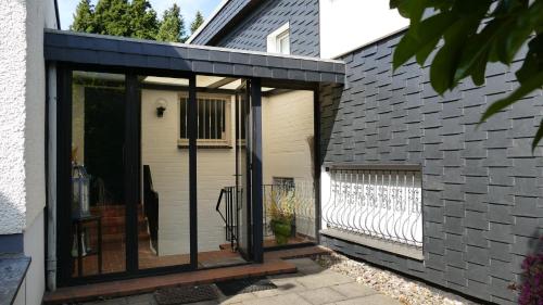 a screened in porch of a house with glass doors at Wuppertal Katernberg in Wuppertal