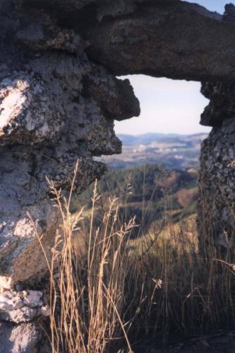 a window in a rock wall with a view at Ferienwohnung Hinterdorfer in Unterweissenbach