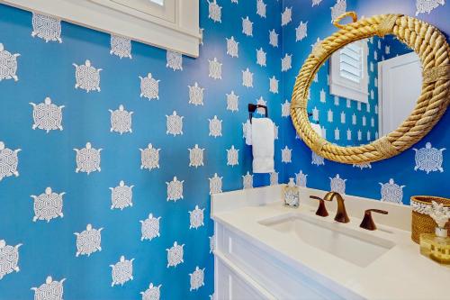 a bathroom with a blue wall with snowman wallpaper at Golf Course Living at Palmilla Beach in Port Aransas