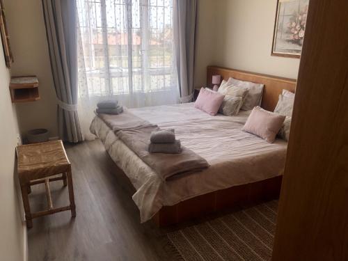 a bedroom with a large bed with two towels on it at Sonneneck 7 in Swakopmund