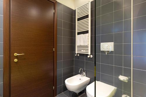 a bathroom with a toilet and a sink at B&B HOTEL Malpensa Lago Maggiore in Vergiate