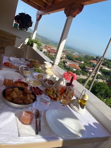a breakfast table with food on a table with a view at Guesthouse & Hospitality in Berat